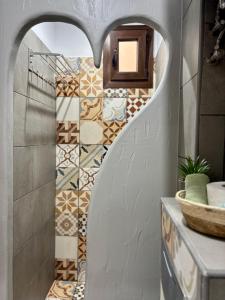 a bathroom with a heart shaped wall at Villa Kaldera Skiathos in Skiathos +52 photos