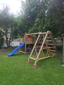 a wooden playground with a slide and a slideintend at apartment Ravelli in Piano