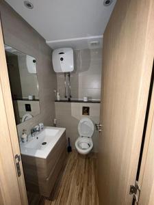a bathroom with a toilet and a sink and a mirror at Studio proche clinique akdital ain sebaa in Casablanca +16 photos