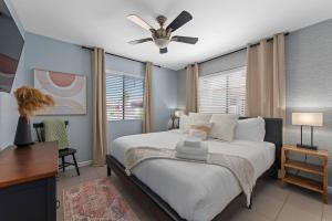 a bedroom with a large bed with a ceiling fan at The Tempe Designer Home! Pets Stay Free! in Tempe +22 photos