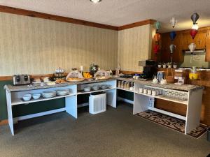 a kitchen with a counter with dishes on it at New Age Inn - Voyageur in Yarmouth
