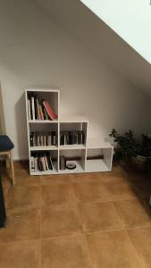a white book shelf with books on it at Townhouse with pool next to the City of Arts in Valencia