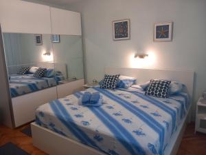 a bedroom with two beds and a large mirror at House Boris in Slatine