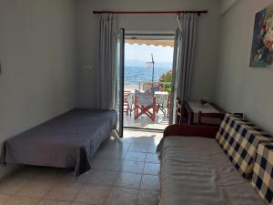 a bedroom with two beds and a view of the ocean at Iria Bay in Iria