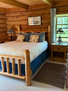 a bedroom with a bed in a log cabin at Trail Creek Ranch in Wilson