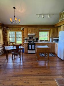 a kitchen with wooden cabinets and a table and chairs at Trail Creek Ranch in Wilson