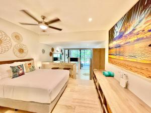 a bedroom with a bed and a large painting on the wall at Syrena Condo Rentals in Playa del Carmen +35 photos
