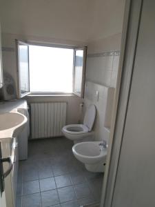 ヴァレンナにあるCasa sullo Speroneのバスルーム(トイレ、洗面台付)、窓が備わります。
