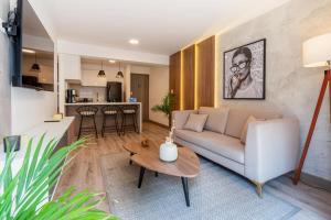 a living room with a couch and a table at Alta Apartments by Geko in Lima +78 photos