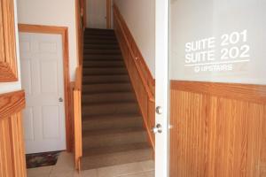 a staircase in a house with a sale sign on the door at Surround Sound in Nags Head +11 photos