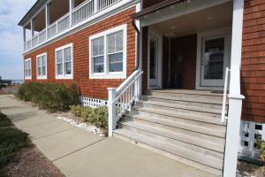 a house with a wooden staircase leading to the front door at Surround Sound in Nags Head
