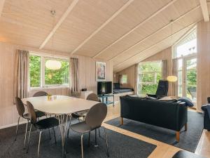 a living room with a table and a couch at 6 person holiday home in Hadsund in Hadsund