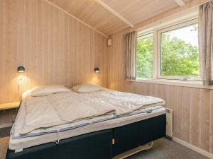 a large bed in a room with a window at 6 person holiday home in Hadsund in Hadsund