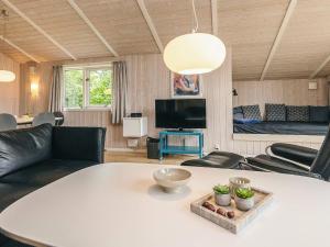 a living room with a white table and a couch at 6 person holiday home in Hadsund in Hadsund
