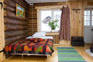 a bedroom with a bed and a wooden wall at Laugu Holiday Resort in Laugu