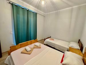 a room with two beds with towels on them at Mountin View Villa & Rafting In Permet in Përmet