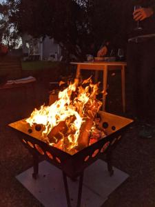 a fire in a grill in a yard at night at Maleny-Montville Cottages #1 - 2 bed ocean views in Balmoral Ridge