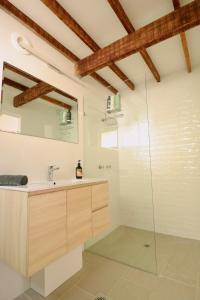 a bathroom with a sink and a glass shower at Maleny-Montville Cottages #1 - 2 bed ocean views in Balmoral Ridge