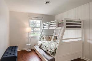 a white bunk bed in a room with a window at Dayton Family Home with Game Room Walk to City Park in Dayton +25 photos
