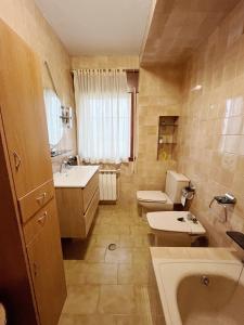 a bathroom with a sink and a toilet and a tub at Casa María in Santa Eulalia +22 photos