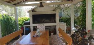 a patio with a table and a television on a patio at Holiday home in Sv. Filip i Jakov 53599 in Sveti Filip i Jakov