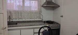 a kitchen with a sink and a stove and a window at Alquilo Casa en Barrio Bombal in Barraquero