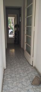 a hallway with a door and a room with a car at Alquilo Casa en Barrio Bombal in Barraquero +2 photos