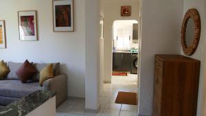 a living room with a couch and a kitchen at Appartement Sabah A Essaouira in Ghazoua +5 photos