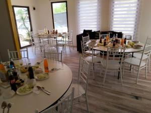 a dining room with tables and chairs with food on them at El secreto de la abuela spa in Talca