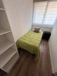 a small bedroom with a bed and a window at El secreto de la abuela spa in Talca