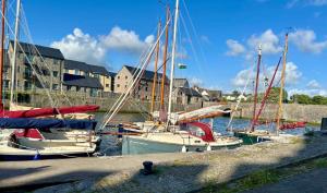a group of boats are docked in a harbor at House in the heart of Pembroke in Pembroke