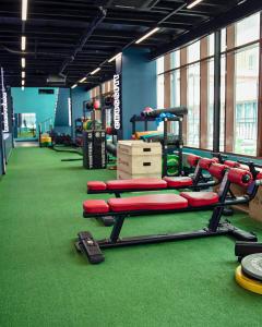 a gym with red equipment on a green floor at Baku - Park Azure with sea view two bedrooms and one living room in Baku +20 photos
