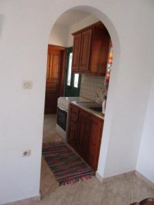 a kitchen with an archway in the middle of it at Kalotina's Apartments in Emborios Kalymnos