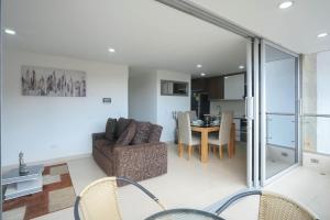 a living room with a couch and a table at Luxury air conditioning near laureles in Medellín