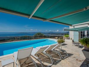 a patio with chairs and a swimming pool at Lessix 8 in Saint-Peïre-sur-Mer