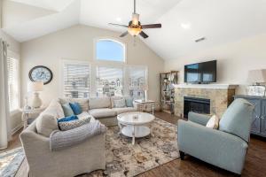 a living room with a couch and a fireplace at Stella Blue in Corolla