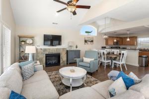 a living room with a couch and a table at Stella Blue in Corolla
