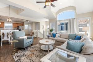 a living room with a couch and a table at Stella Blue in Corolla