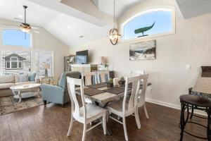 a dining room and living room with a table and chairs at Stella Blue in Corolla +32 photos