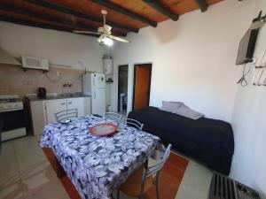 a room with a table and a bed and a kitchen at MARY ORM House 2 in Malargüe