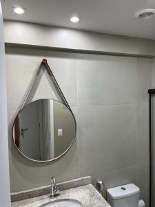 a bathroom with a mirror and a sink at Tamandaré Refúgio Luxuoso com Piscina Infinita e Mar Azul in Tamandaré