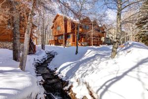 a snow covered path in front of a house at KBM Resorts Timber Wolf Lodge Mountain Elegance with Gas Fireplace Common Hot Tubs Near Canyons Village TWL-5b in Park City