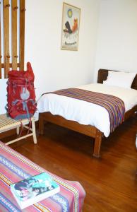 a bedroom with a bed with a red backpack on it at Maison Fortaleza in Cusco +69 photos