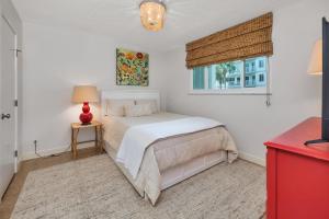 Un dormitorio blanco con una cama y una ventana. en North Breakers #208, en Saint Simons Island 18 fotos más