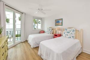 a bedroom with two beds and a window at North Breakers #211 in Saint Simons Island +29 photos