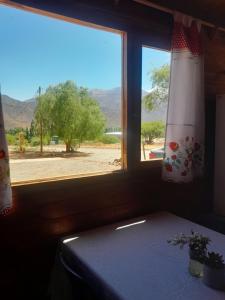 a room with a table and a window with a view at Cabaña Cachi in Cachí