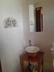 a bathroom with a bowl sink and a mirror at Cabaña Cachi in Cachí