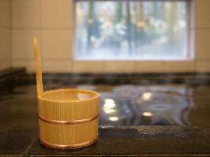 a yellow cup with a wooden spoon sitting on a counter at Super Hotel Hida Takayama in Takayama