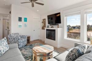 a living room with a couch and a fireplace at Sunset On The Sound in Kill Devil Hills