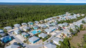 an overhead view of a resort with a road and trees at Paradise Found Gulf Shores Beach Pools Dogs in Gulf Shores